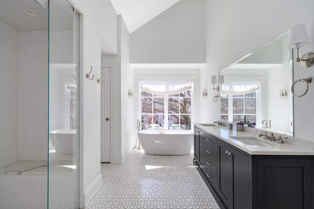 full bath featuring double vanity, a soaking tub, high vaulted ceiling, and a sink