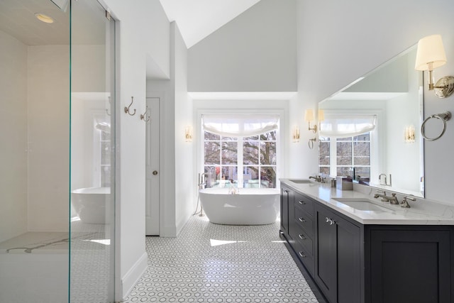 2852 W Mclean Ave, Chicago, IL 60647 - bathroom featuring a sink, high vaulted ceiling, a freestanding bath, and double vanity