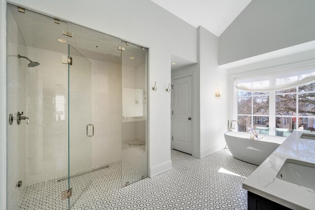 2852 W Mclean Ave, Chicago, IL 60647 - bathroom with a shower stall, baseboards, high vaulted ceiling, a soaking tub, and vanity