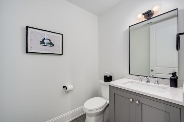 bathroom featuring visible vents, baseboards, toilet, and vanity