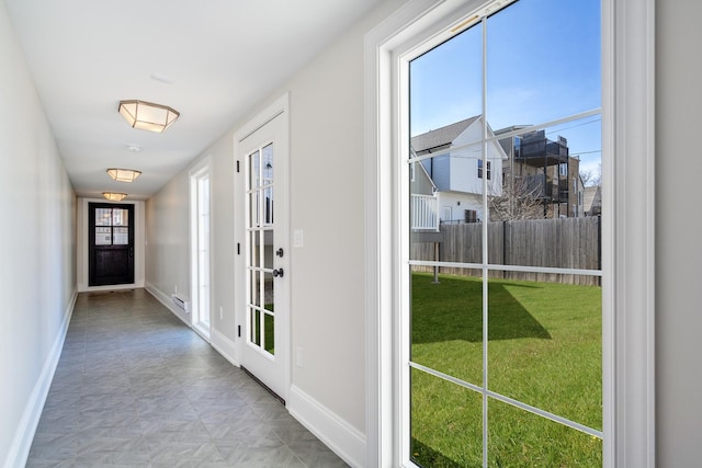 doorway featuring baseboards