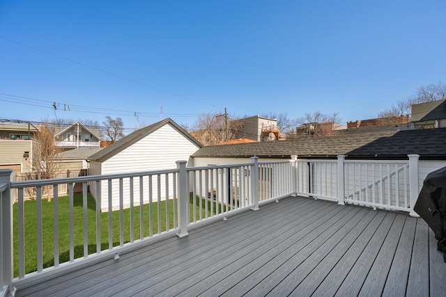 deck with a lawn and an outdoor structure