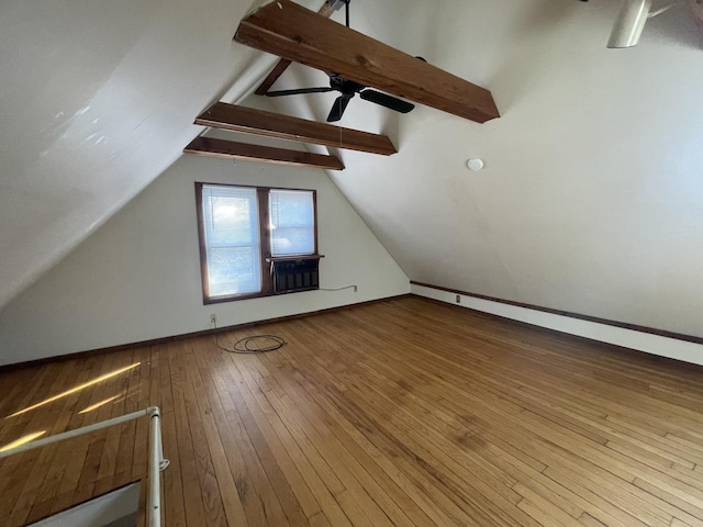 bonus room with lofted ceiling with beams, ceiling fan, and wood-type flooring