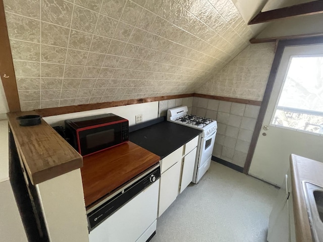 kitchen with white appliances, lofted ceiling, butcher block countertops, white cabinets, and tile walls