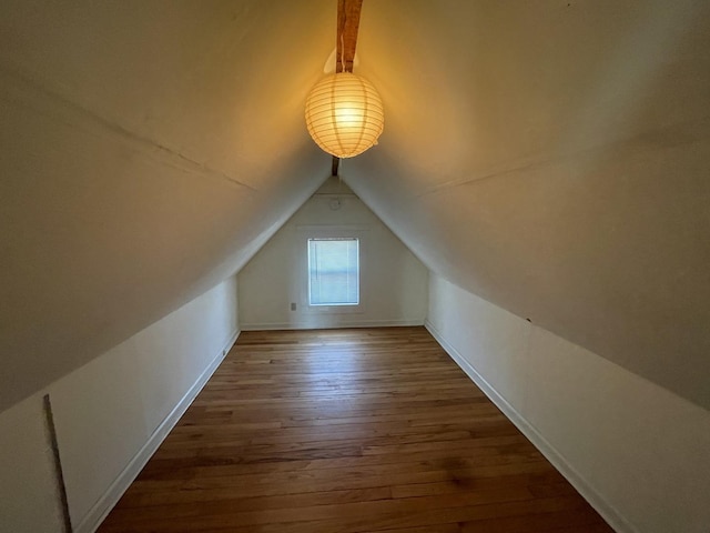 bonus room featuring baseboards, lofted ceiling, and hardwood / wood-style floors