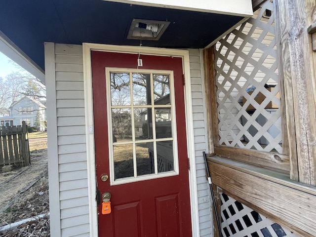 view of exterior entry featuring fence