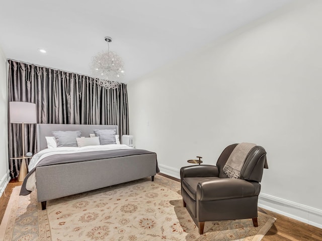 bedroom featuring recessed lighting, baseboards, an inviting chandelier, and light wood-style flooring