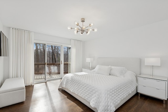 bedroom with wood finished floors, a chandelier, and access to outside