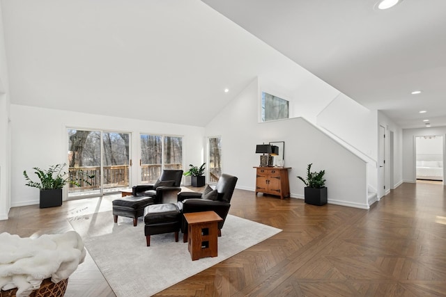 living area featuring baseboards, high vaulted ceiling, and recessed lighting