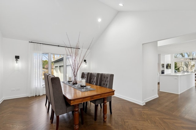 dining space featuring baseboards, high vaulted ceiling, and recessed lighting