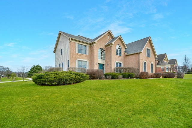 view of front of house with brick siding and a front lawn