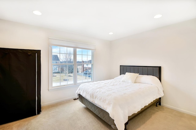 bedroom with recessed lighting, baseboards, and light colored carpet