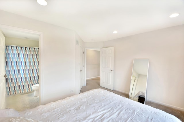 bedroom with recessed lighting, baseboards, and ensuite bath