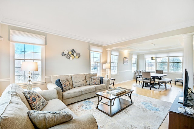 living area with light wood-type flooring, ornamental molding, and ornate columns