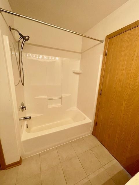 full bathroom featuring tile patterned floors and shower / tub combination