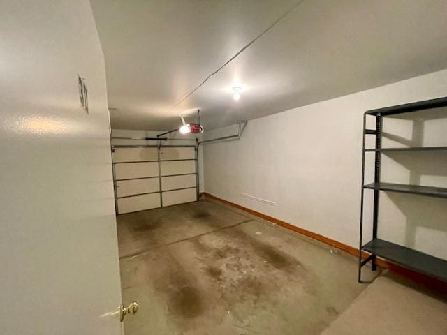 garage featuring a garage door opener and baseboards