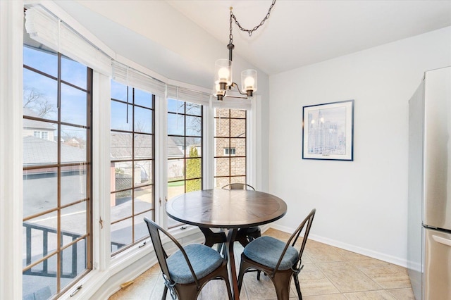 dining area featuring baseboards, an inviting chandelier, light tile patterned flooring, and a healthy amount of sunlight