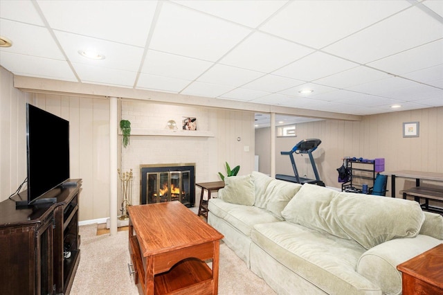 living area featuring recessed lighting, a drop ceiling, a brick fireplace, and carpet flooring