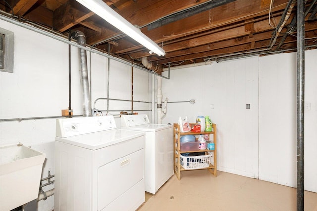 laundry area featuring washing machine and clothes dryer, laundry area, and a sink