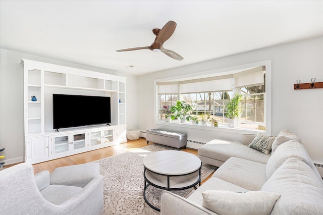 living room with baseboard heating, ceiling fan, and wood finished floors