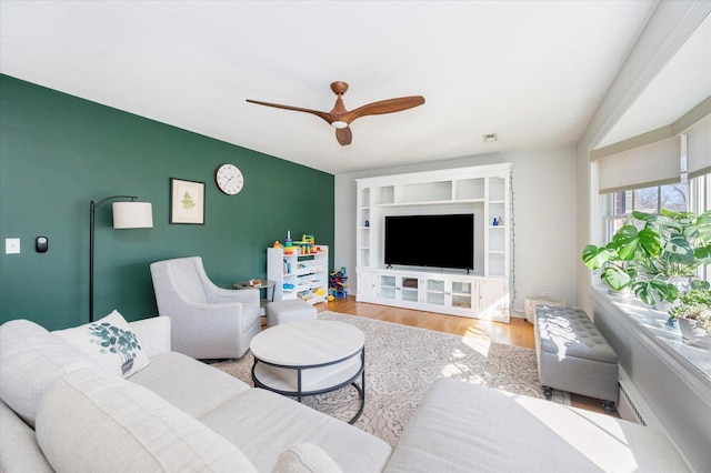 living room featuring a ceiling fan and wood finished floors