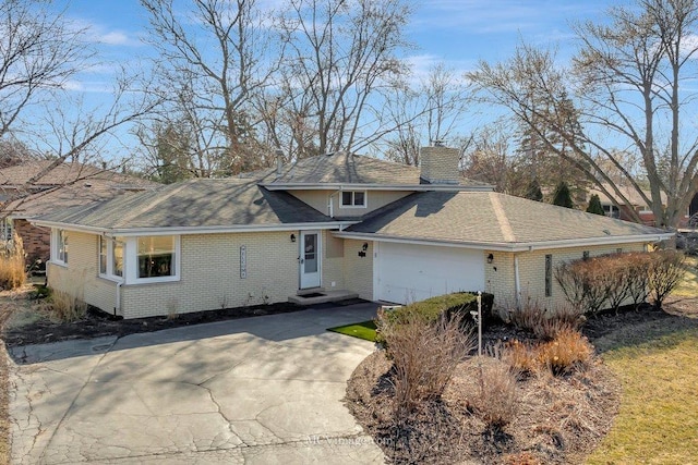 view of front of house featuring brick siding, concrete driveway, roof with shingles, a chimney, and a garage