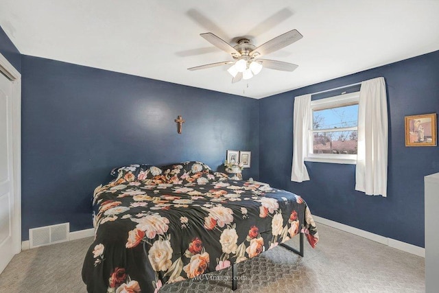 carpeted bedroom featuring visible vents, baseboards, and a ceiling fan