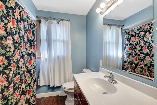 full bath featuring toilet, wood finished floors, and vanity