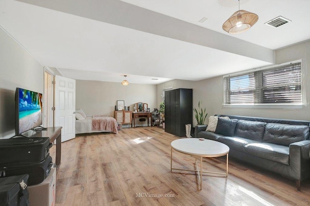 living room featuring visible vents and light wood-style floors