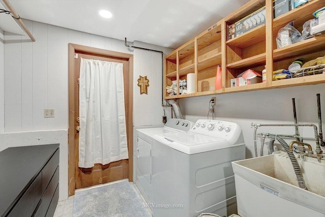 laundry area with laundry area, recessed lighting, separate washer and dryer, and a sink