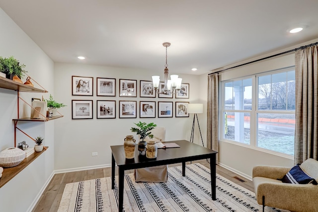 office space with an inviting chandelier, light wood-style flooring, recessed lighting, and baseboards