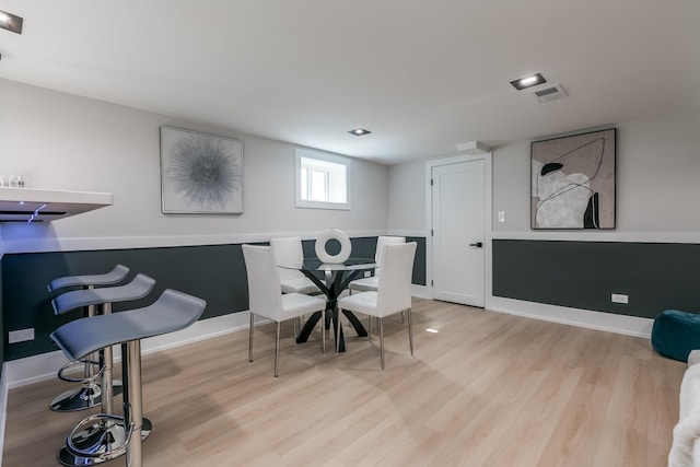 dining space featuring visible vents, baseboards, and light wood-style floors