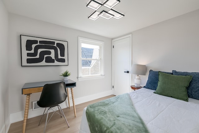 bedroom featuring baseboards and wood finished floors