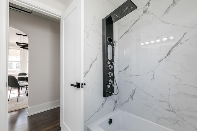 full bathroom with visible vents, shower / bathtub combination, baseboards, and wood finished floors