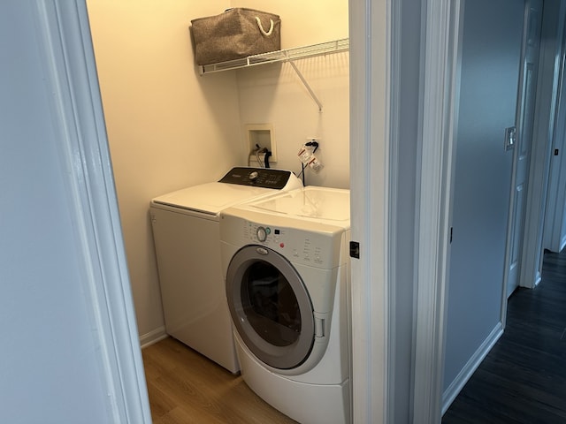 clothes washing area with laundry area, dark wood-style floors, and independent washer and dryer