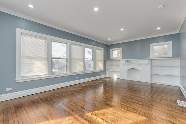 unfurnished living room with visible vents, wood-type flooring, baseboards, and a fireplace