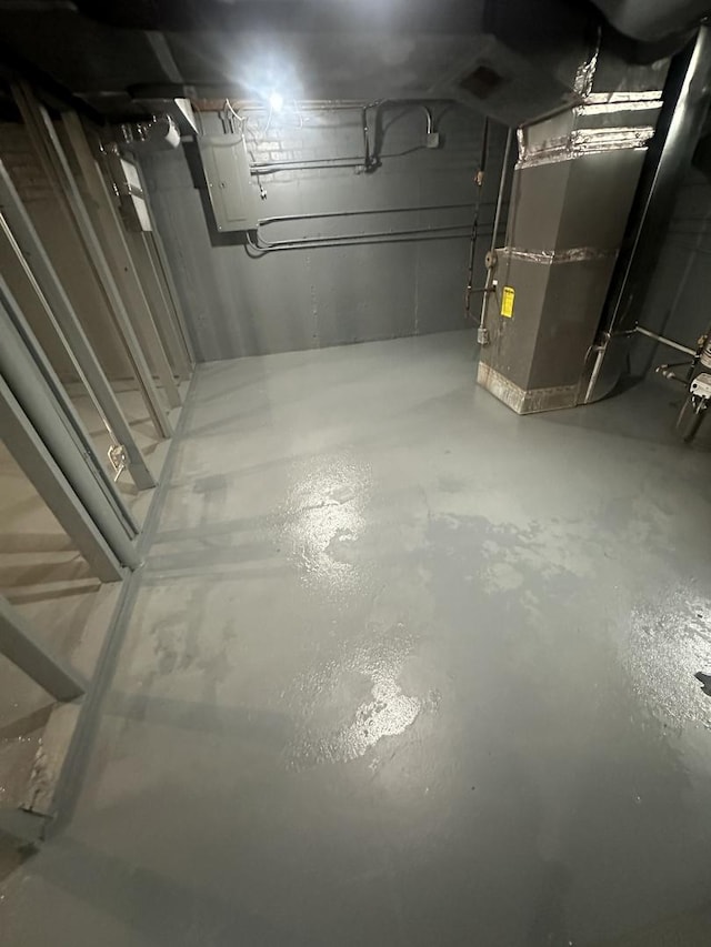 unfinished below grade area featuring heating unit