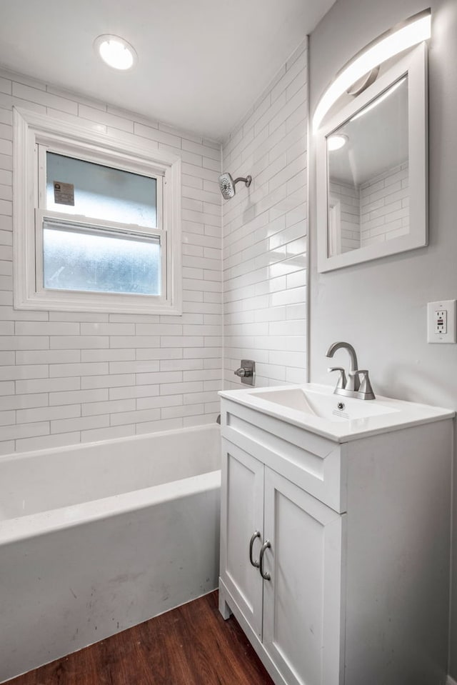 full bathroom with shower / bathtub combination, wood finished floors, and vanity