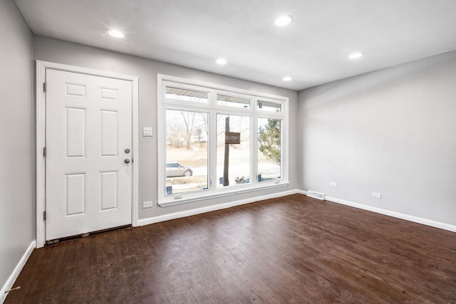 entryway with dark wood finished floors, visible vents, recessed lighting, and baseboards