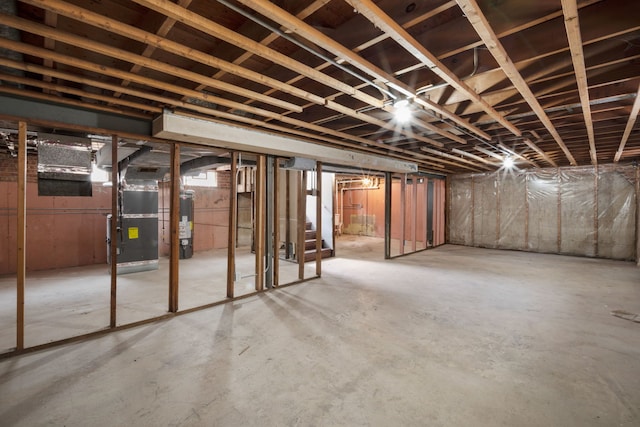 unfinished basement with heating unit and water heater