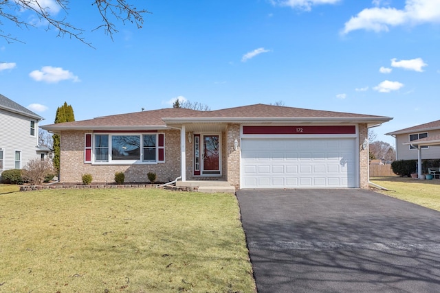 ranch-style home with brick siding, driveway, an attached garage, and a front yard