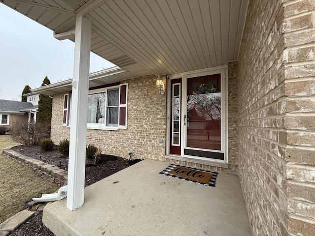 view of exterior entry with brick siding