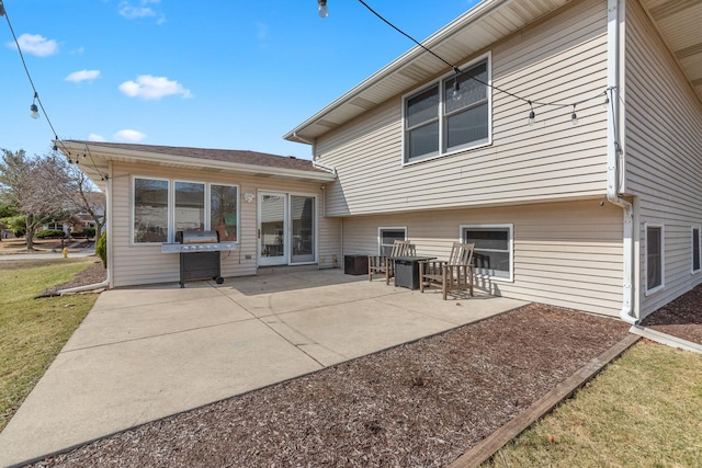 rear view of house with a patio area and a yard