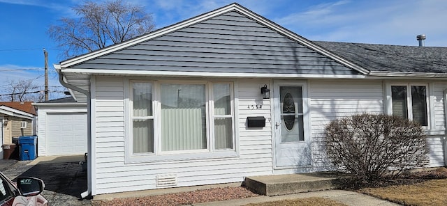 view of front facade with a shingled roof and crawl space