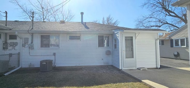 rear view of property with central AC