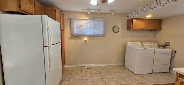 laundry room featuring visible vents, baseboards, light tile patterned floors, rail lighting, and washer and dryer