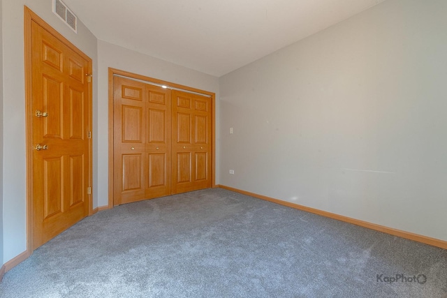 unfurnished bedroom featuring a closet, visible vents, baseboards, and carpet floors