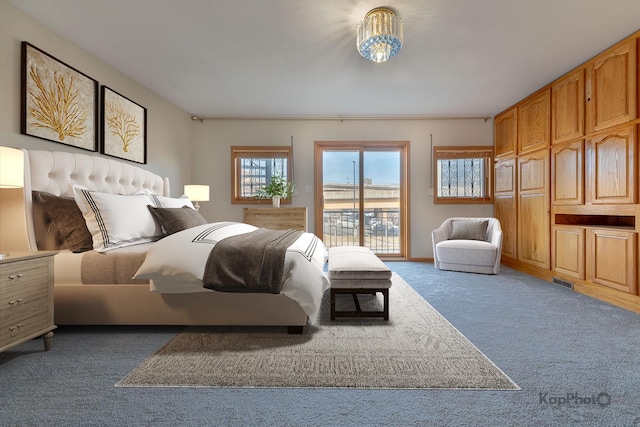 carpeted bedroom featuring access to outside and visible vents