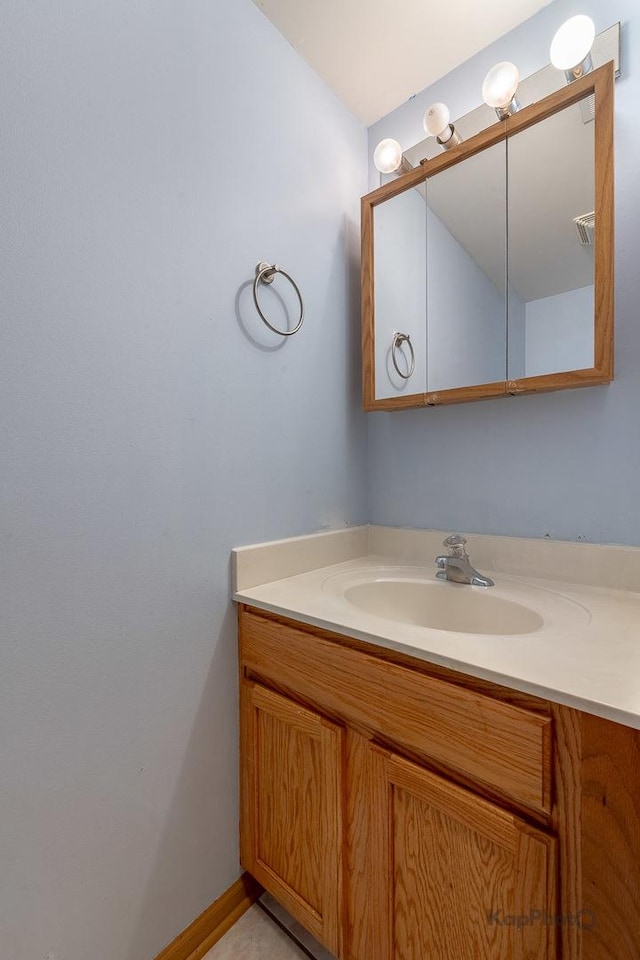 bathroom with lofted ceiling and vanity