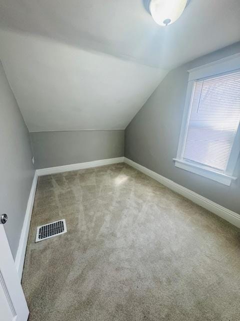 bonus room with visible vents, baseboards, carpet, and vaulted ceiling